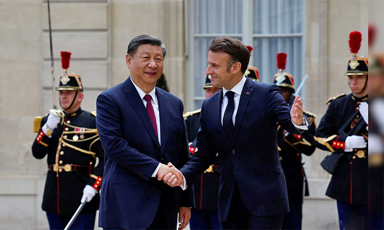 Emmanuel Macron (right) welcomes Xi Jinping before their meeting at the Elysee Palace in Paris. Reuters