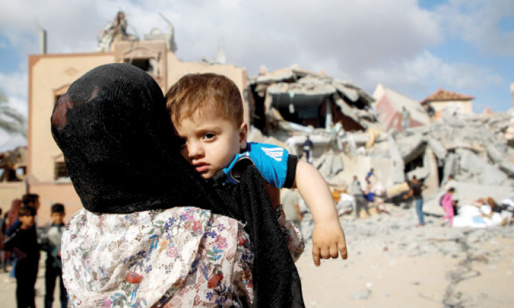 A Palestinian child looks on at the site of an Israeli strike on a house in Rafah, in the southern Gaza Strip.   Reuters