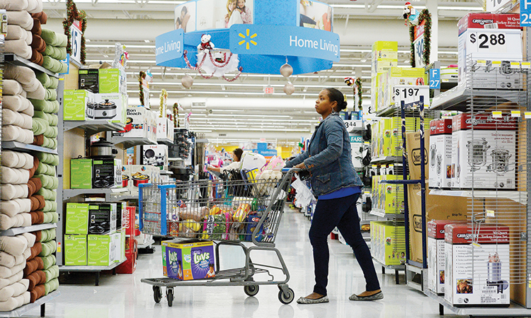 A customer pushes her shopping cart through the aisles at store in Los Angeles.  File/Reuters