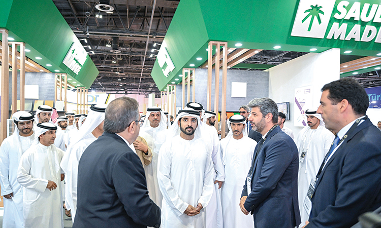 Sheikh Hamdan interacts with officials at the exhibition venue in Dubai on Monday.