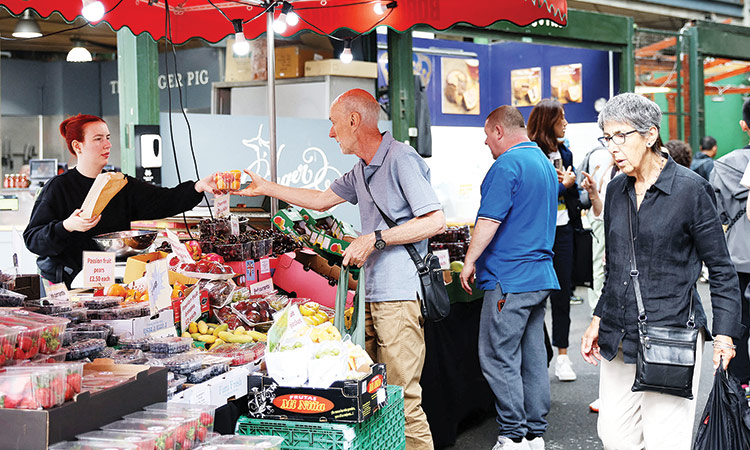 People shop at Borough Market in London, Britain. Reuters