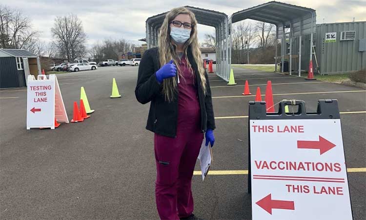 Chania Batten waits to administer COVID-19 vaccines at a drive-thru clinic in Spencer, Virginia. Associated Press
