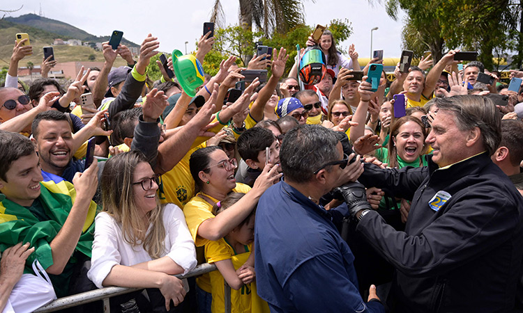 Jair Bolsonaro greets supporters while arriving to a rally at the Ronaldao stadium in Pocos de Caldas, Minas Gerais state, Brazil.  File/AFP