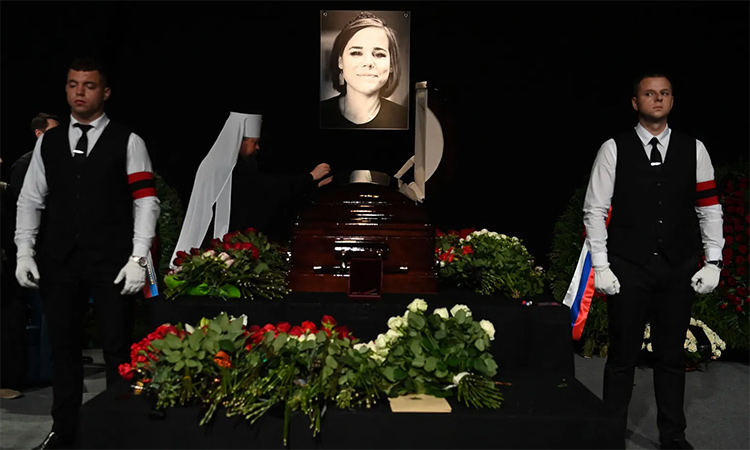 A portrait of Darya Dugina is displayed near her coffin at a ceremony at the Ostankino television complex in Moscow on Aug.23. AFP