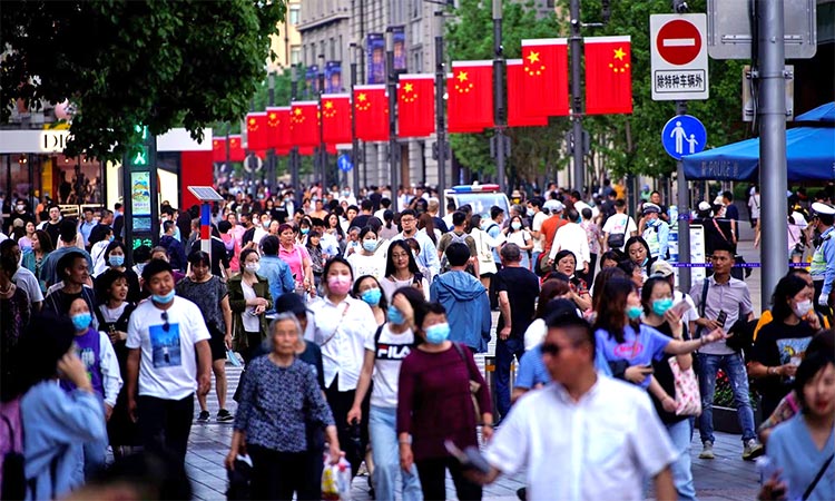 People walk along Nanjing Pedestrian Road, a main shopping area in Shanghai. Reuters