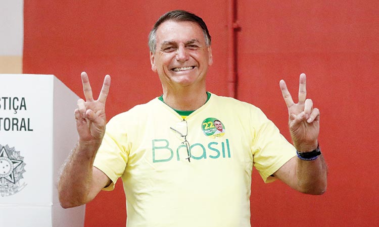 Jair Bolsonaro flashes the victory sign after casting his vote during the presidential run-off election, at a polling station in Rio de Janeiro, Brazil.    File/ AFP