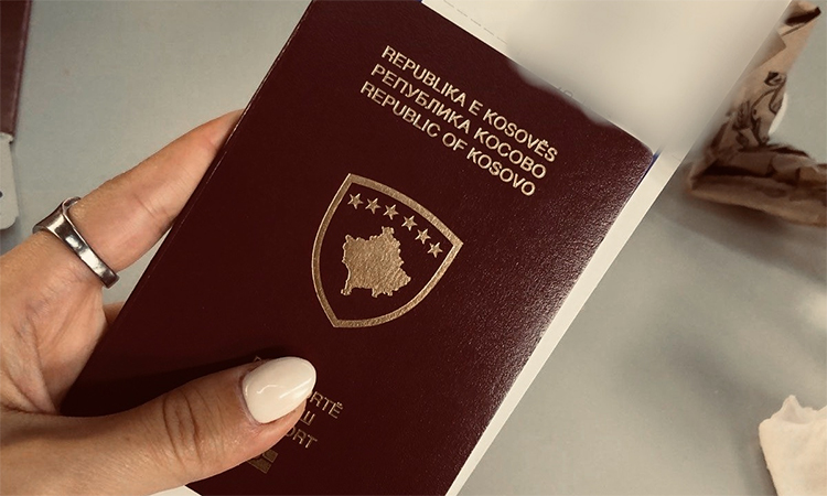 A Kosovo girl holds her passport at the Pristina's International Airport. AFP