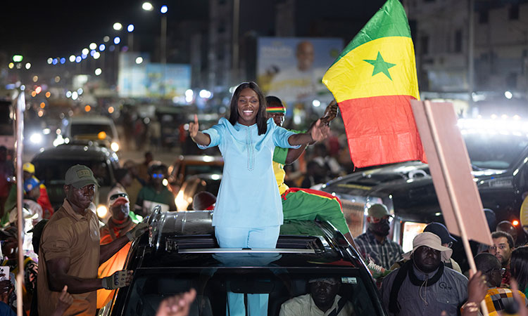 Presidential candidate Anta Babacar Ngom greets supporters during her electoral campaign caravan in Dakar, Senegal. AP