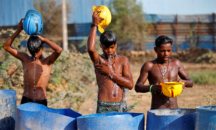 Labourers cool off at a construction site in Ahmedabad, India. File/Reuters