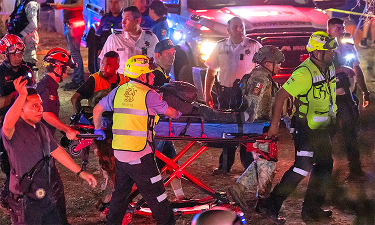 Injured people are carried away from the scene for treatment.