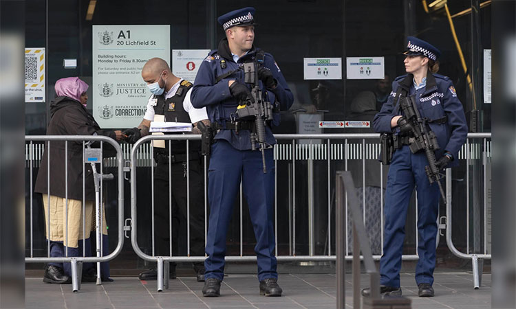 Armed police officers guard the entrance as family of survivors from March 2019 Christchurch mosque shooting line up to enter the Christchurch High Court for day two of the sentencing hearing of Australian Brenton Harrison Tarrant, in Christchurch, New Zealand. 