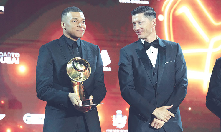 Kylian Mbappe poses with the trophy, presented by Robert Lewandowski, at the inaugural KAFD Globe Soccer Awards Europe in Costa Smeralda in Sardinia on Tuesday.