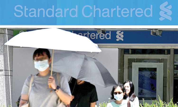 StanChart lowers income target, launches $1 billion share buyback