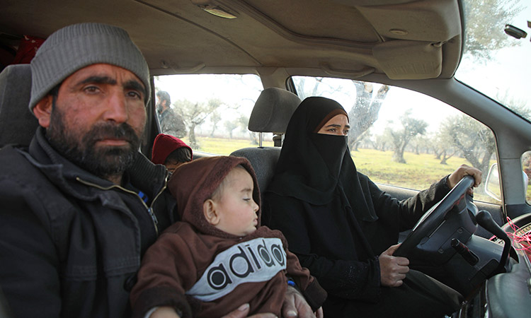 After fleeing war, a Syrian homeless family takes shelter in a car