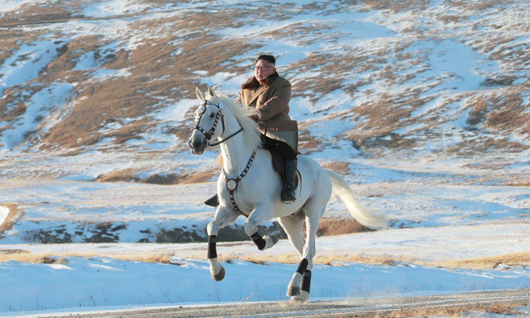 Kim rides white horse on sacred mountain, vows to fight US sanctions