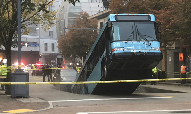 Sinkhole opens, swallows part of city bus during rush hour