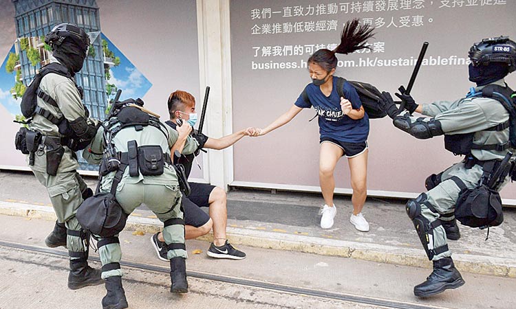 HK protesters defy mask ban as city grinds to a halt