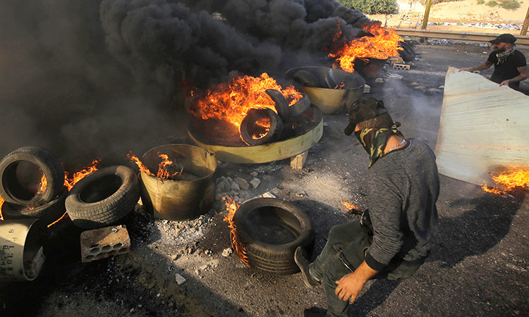 Lebanese protesters back in streets; first death reported