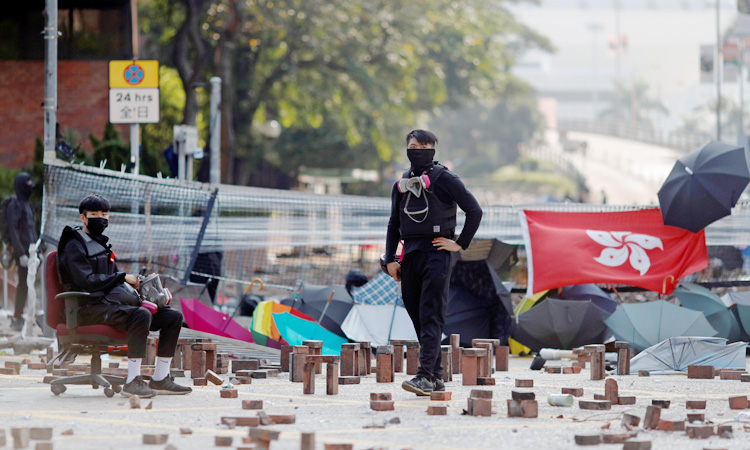 Hong Kong condemns attack on justice secretary as protests paralyze city