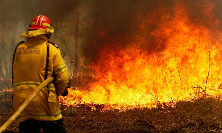 Two dead, dozens injured as Australia wildfires raze homes