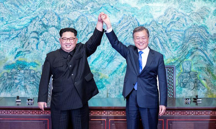 Two Koreas mark Moon-Kim summit anniversary with different tones