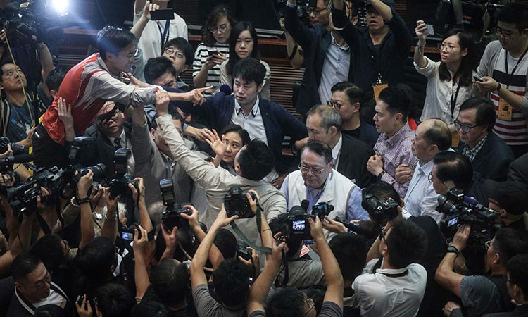 Hong Kong extradition row sparks parliament scuffles