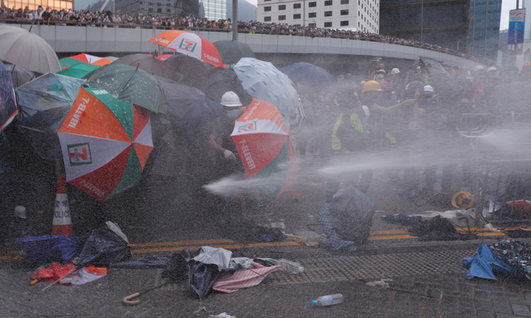 Video: Hong Kong police fire tear gas as protesters throw bottles