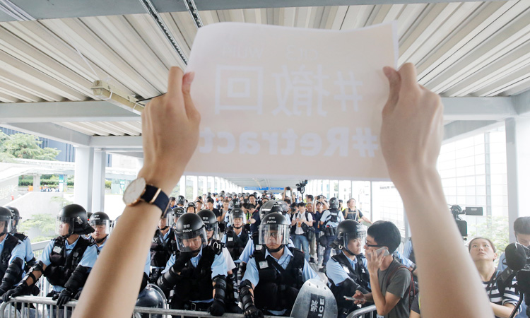 Thousands of Hong Kong protesters gather, govt offices shut after violence