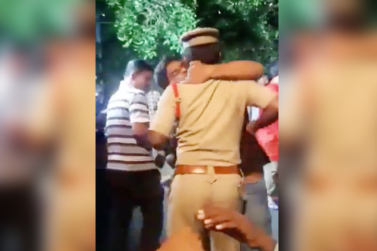 Drunk man kisses policeman in Hyderabad during religious festival