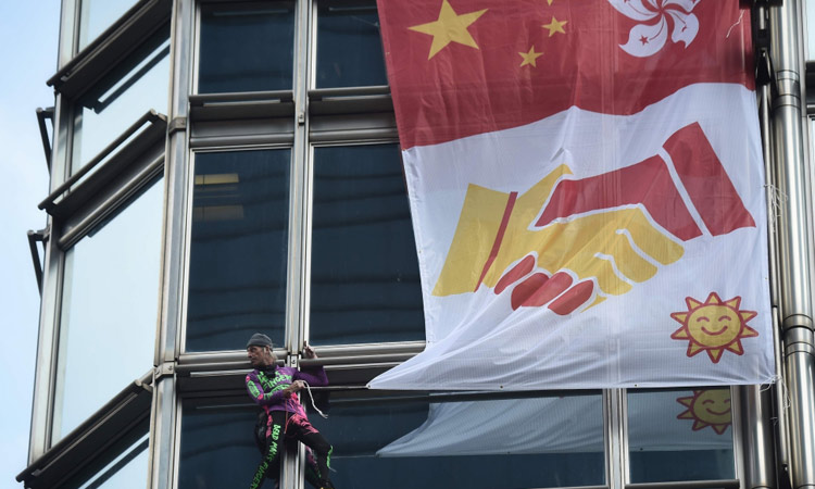  French ‘spiderman’ climbs Hong Kong tower, hoists reconciliation flag amid mass protests