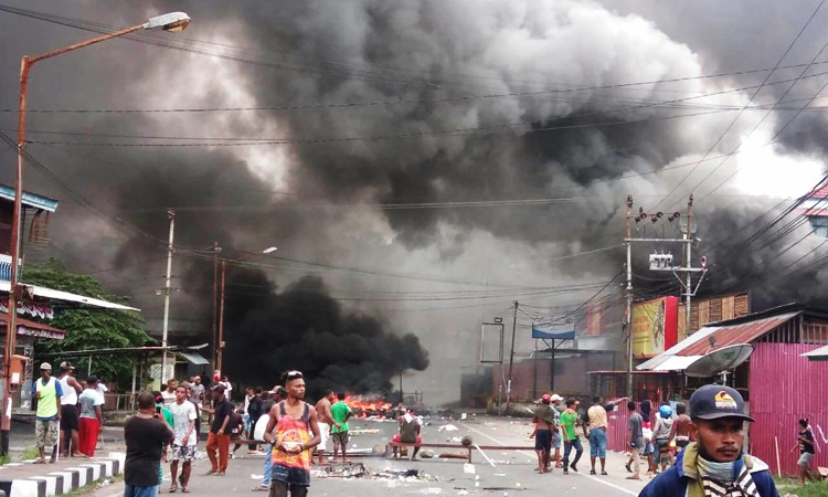 Indonesia protesters torch town hall in Papua over student detentions