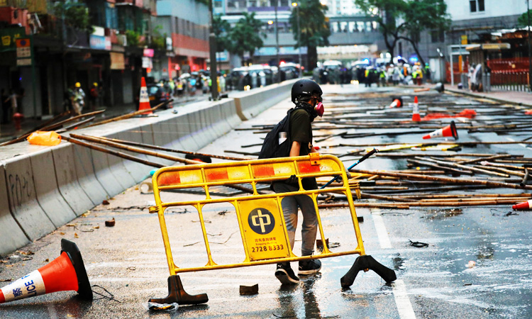 Hong Kong police arrest 36 after running battles with protesters