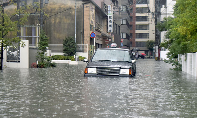 Record rain in south Japan brings flood chaos, kills at least two