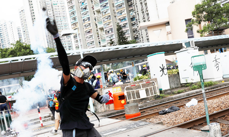 Hong Kong police fire tear gas as strikes paralyse city