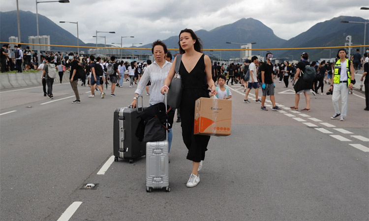 Thousands of Hong Kong protesters block roads, transport links to airport 