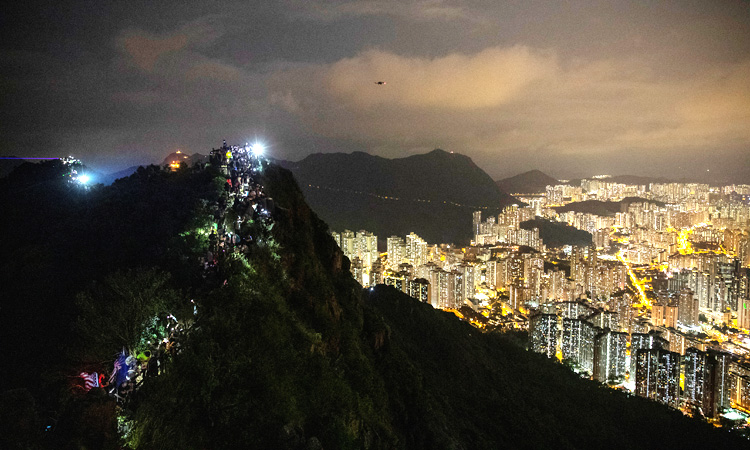 Hong Kong protesters plan mall sit-ins after hill-top human chains