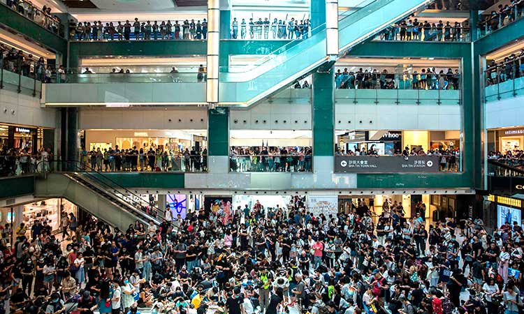 Hong Kong police storm mall after protesters smash rail station