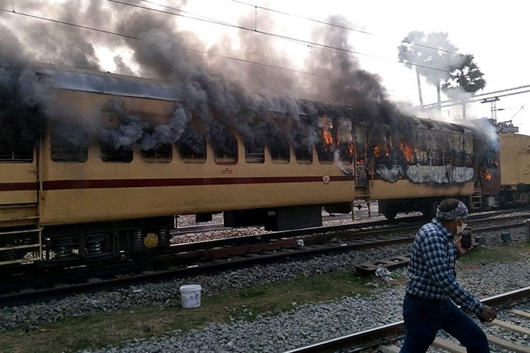 Mobs burn Indian train carriages in rail jobs protest