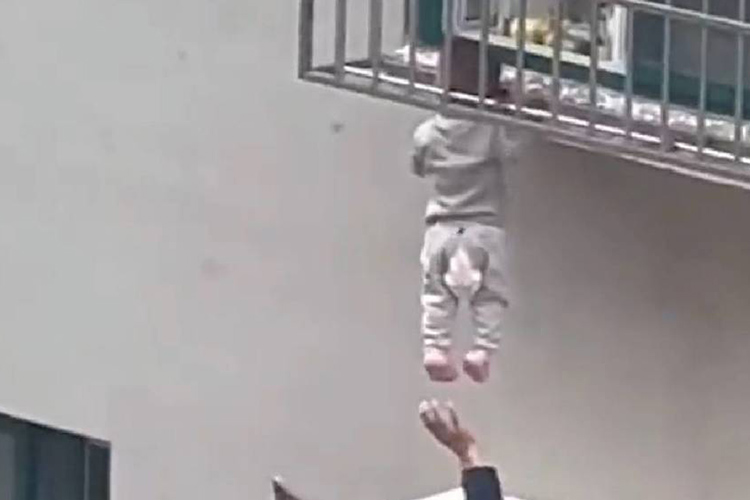 VIDEO: Residents rescue child dangling from highrise in China after head gets stuck in window