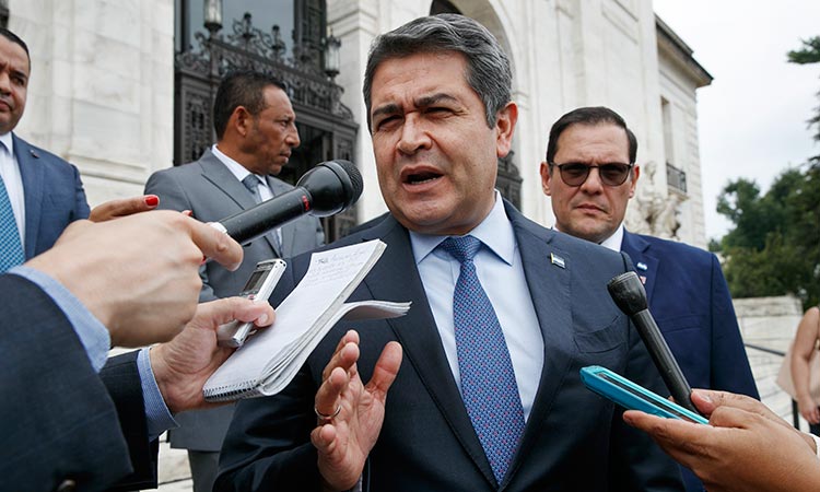 Honduran police surround house of ex-president after US seeks extradition