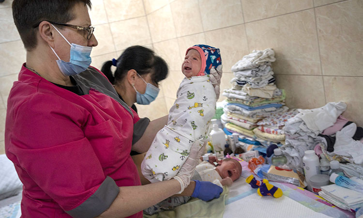 Surrogate babies born in Ukraine wait out war in basement