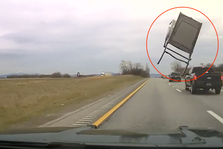 VIDEO: Armchair flies out of pickup and lands on police car in US