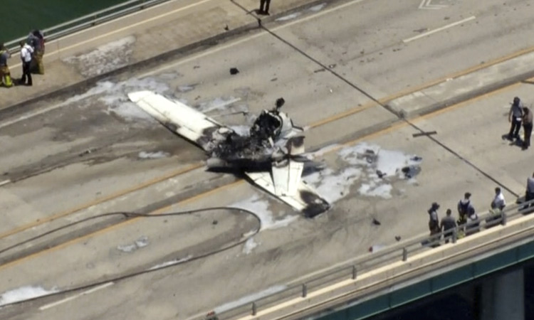 Small plane crashes on bridge near Miami, striking an SUV