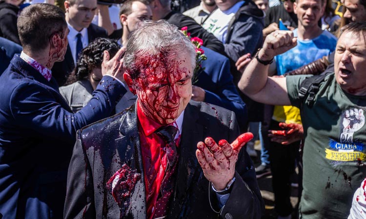 VIDEO: Russian ambassador doused in red by anti-war protesters in Poland