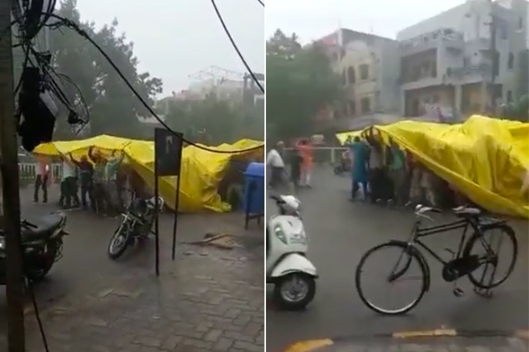 VIDEO: Wedding guests shield themselves from rain with tarpaulin and keep moving towards marriage venue