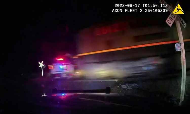 VIDEO: Train slams into police patrol car with suspect in back seat