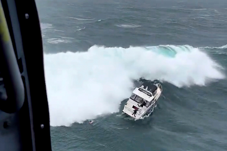 VIDEO: ‘Wanted man’ rescued by Coast Guard after massive wave rolled the yacht he was piloting