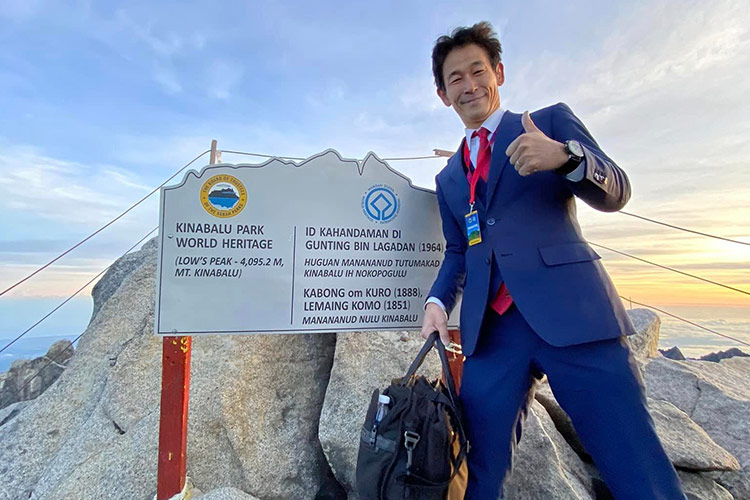 Japanese tailor climbs Malaysia’s highest mountain in a three-piece suit and leather shoes