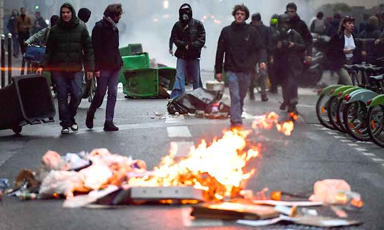 France braces for more protests as Macron signs pension reform into law