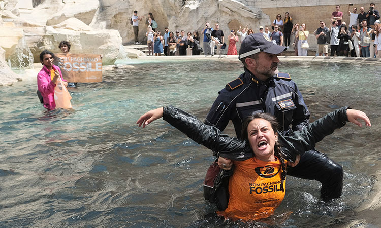 Young climate activists turn Rome's famous Trevi Fountain black